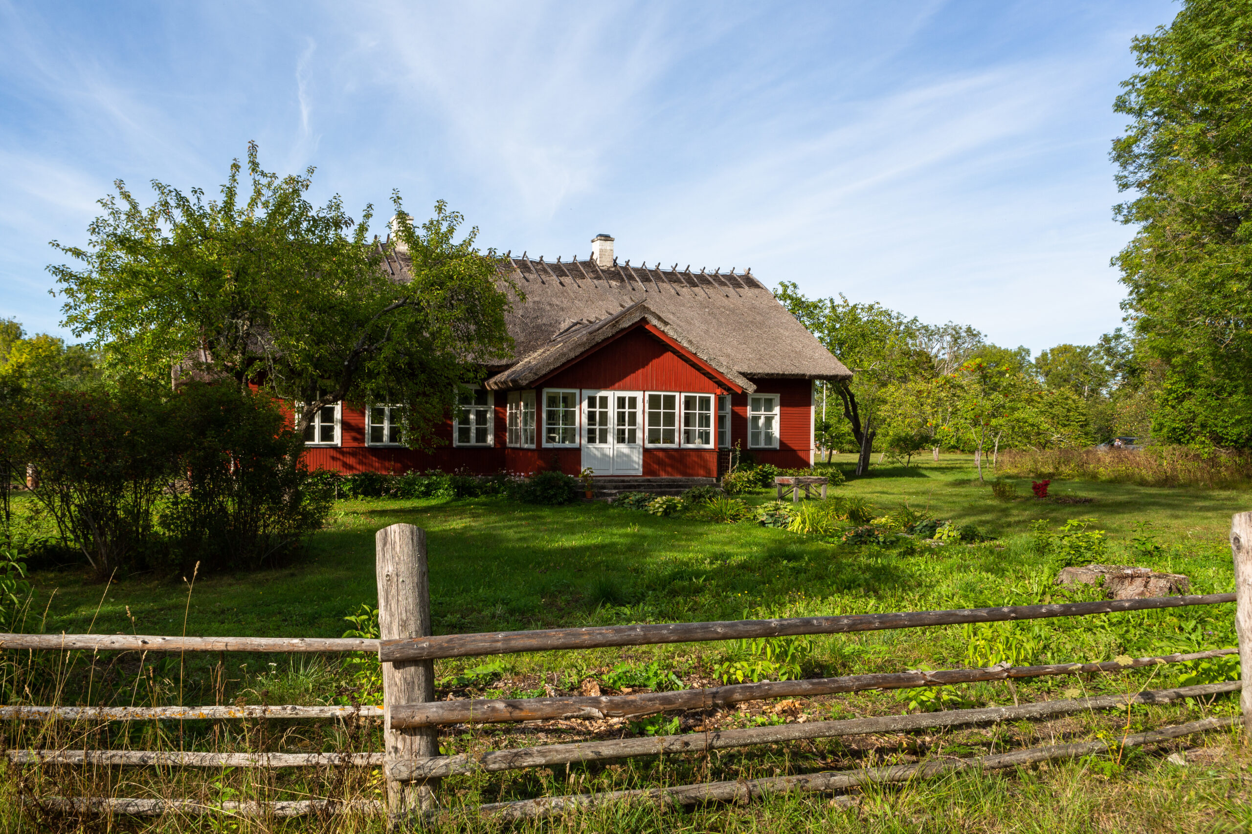 Traditional house in Estonia behind a wooden fence.